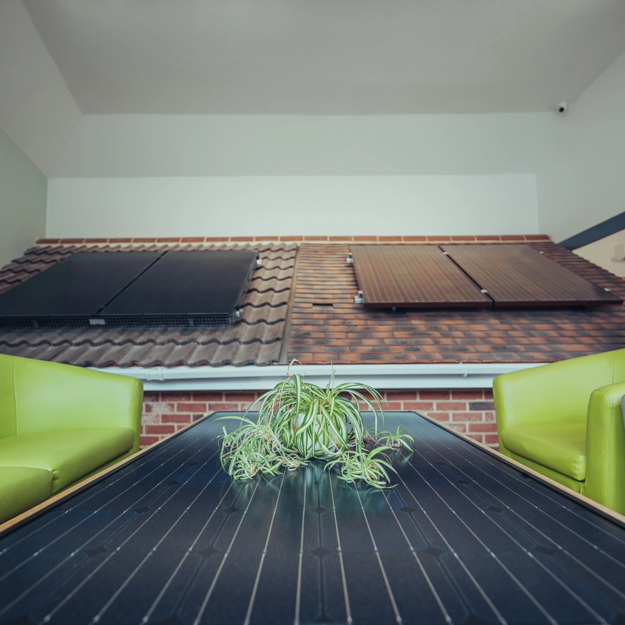 Installers fitting solar panels to a tiled roof