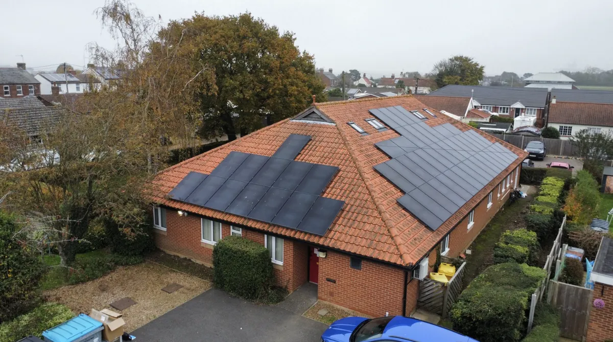 Aerial view of a surgery with solar panels on its tiled roof