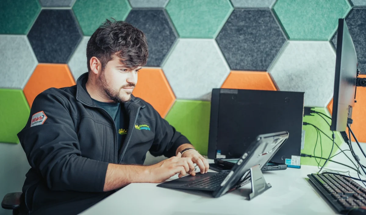 A Greenscape team member working at a laptop in the office