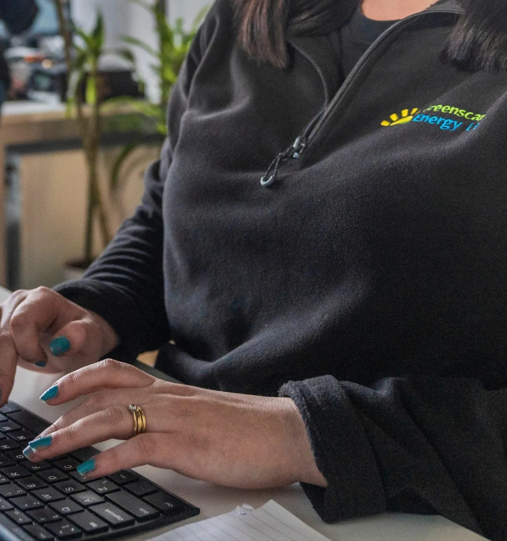 A member of the back-office team typing at a keyboard
