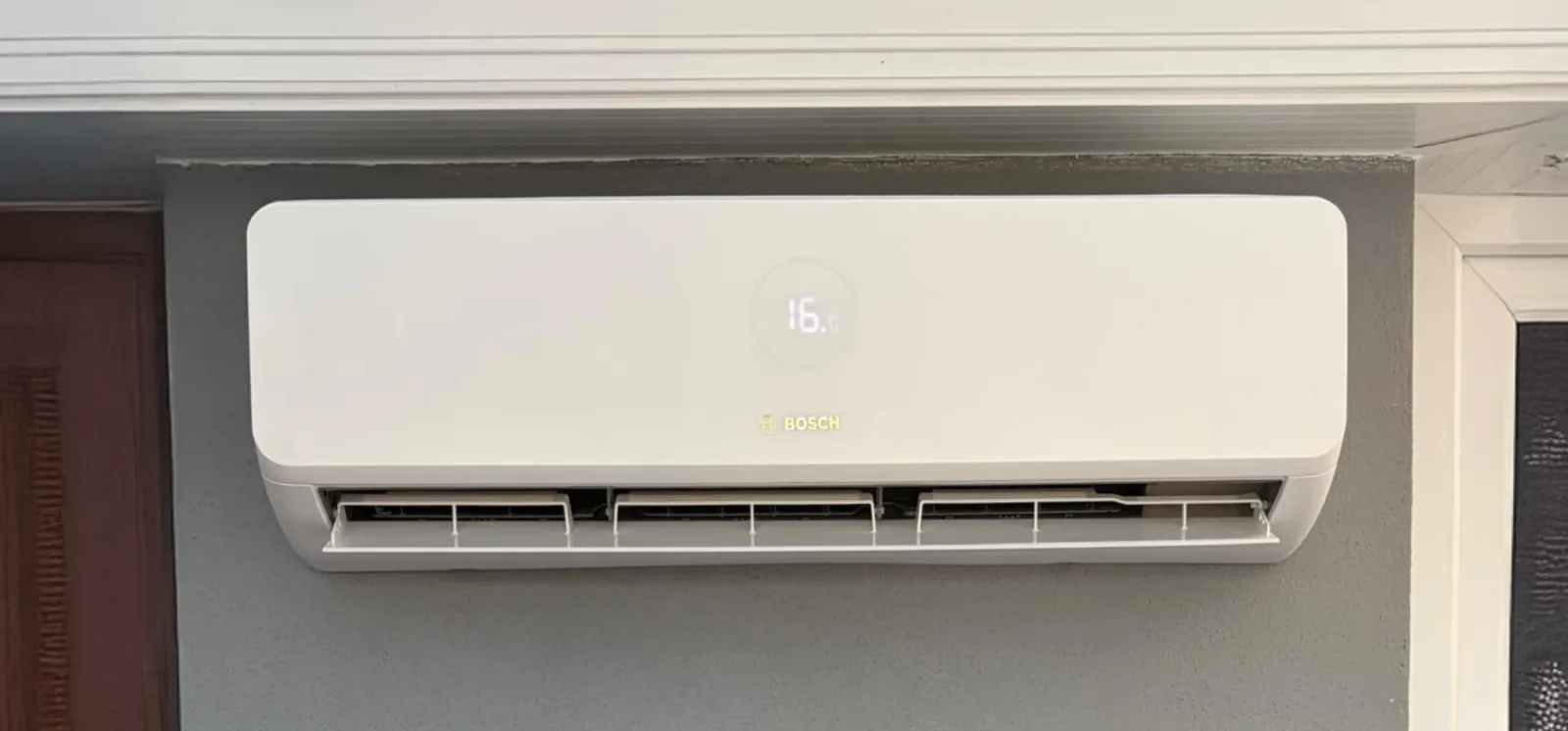 Engineer servicing an installed air conditioning unit