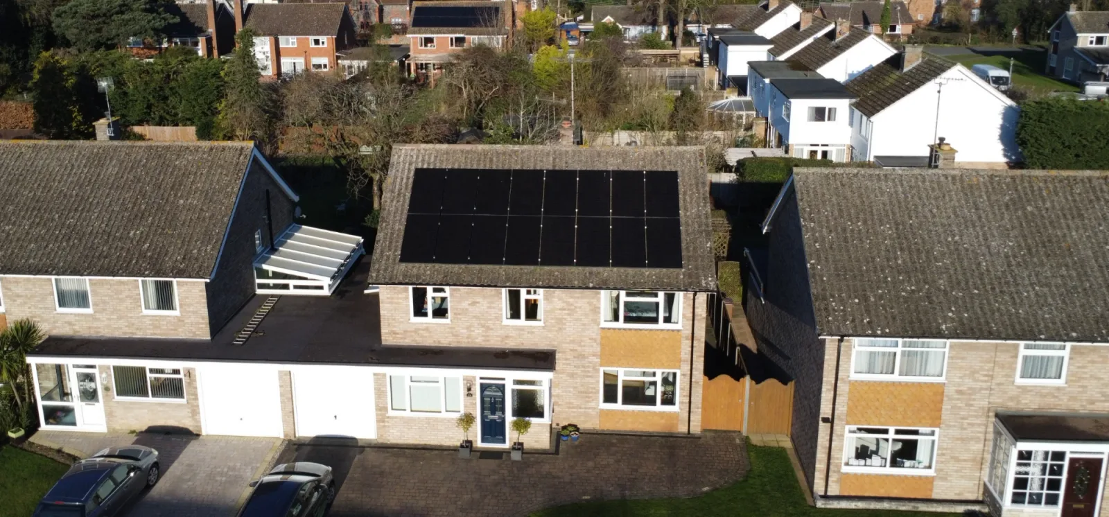 Greenscape installers fitting solar panels to a council-owned building