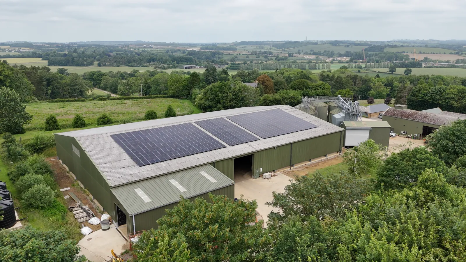 Farm buildings with solar roofs in open countryside