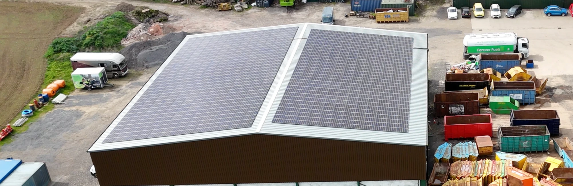 Farm buildings with solar roofs in open countryside