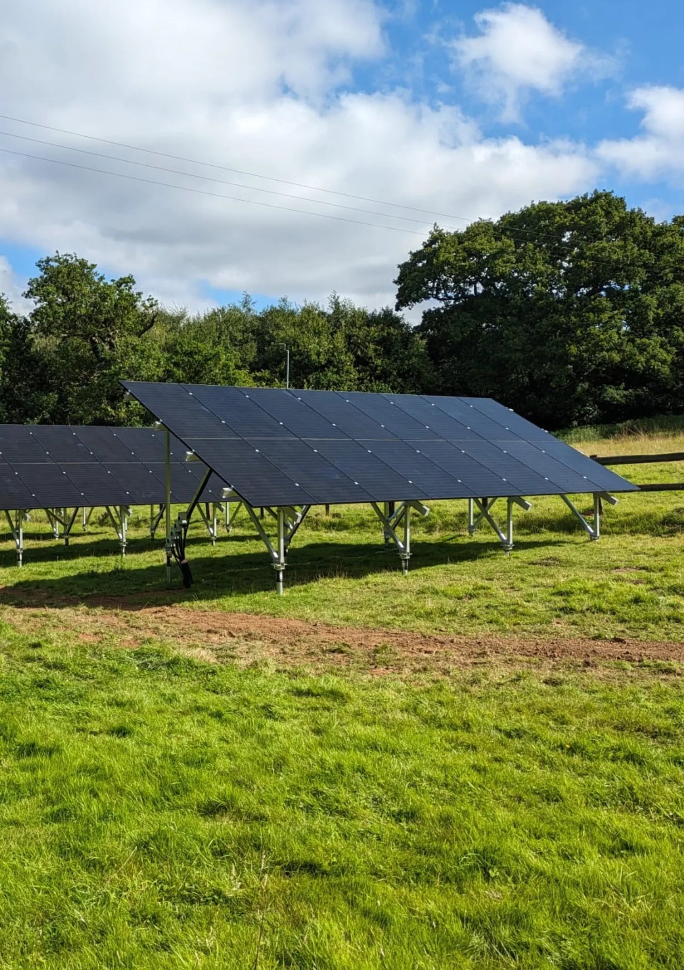 An installer in a hard hat fixing a solar panel