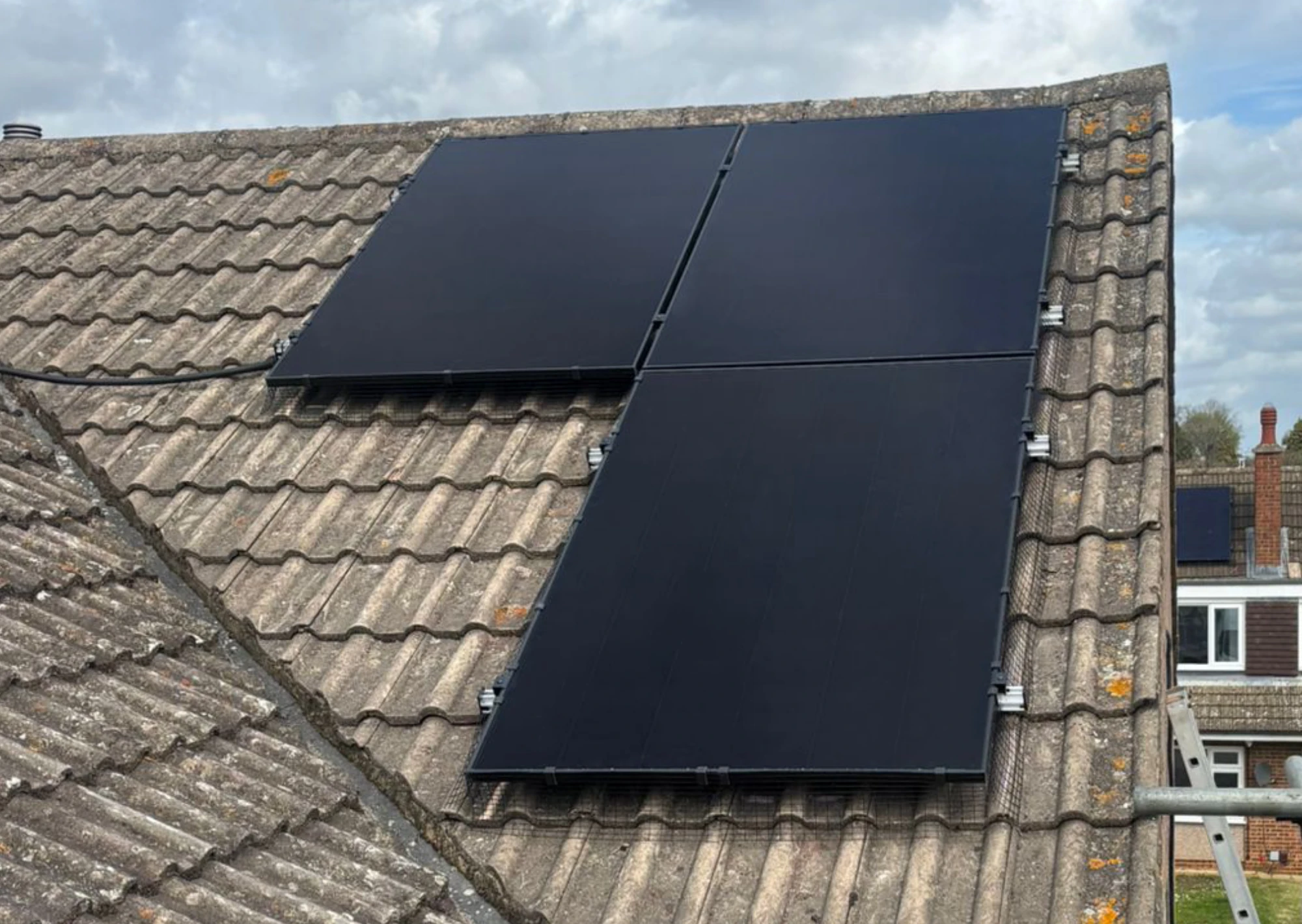 A Greenscape installer fitting panels to a tiled roof