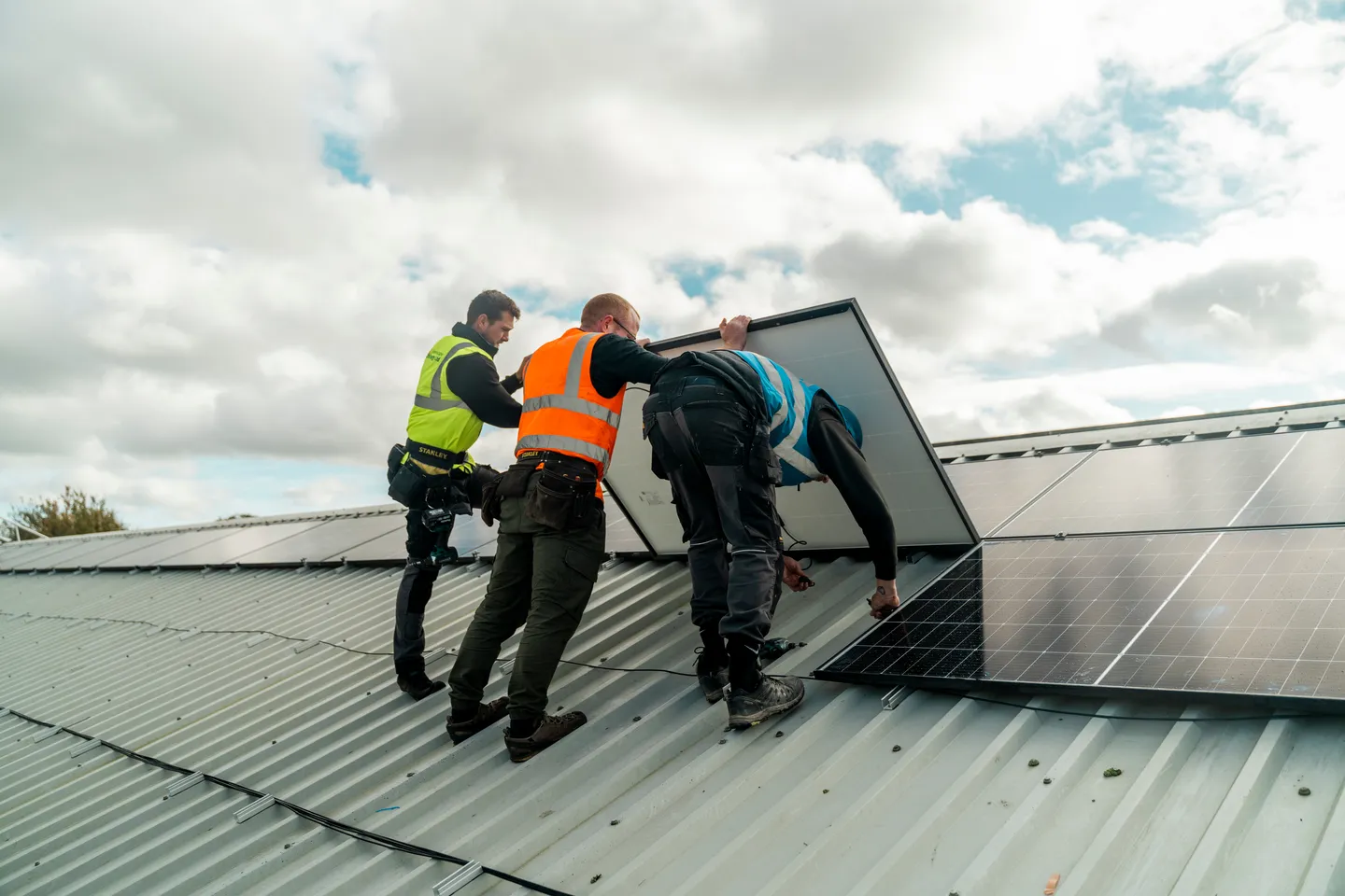 Greenscape installers fitting panels to a commercial roof