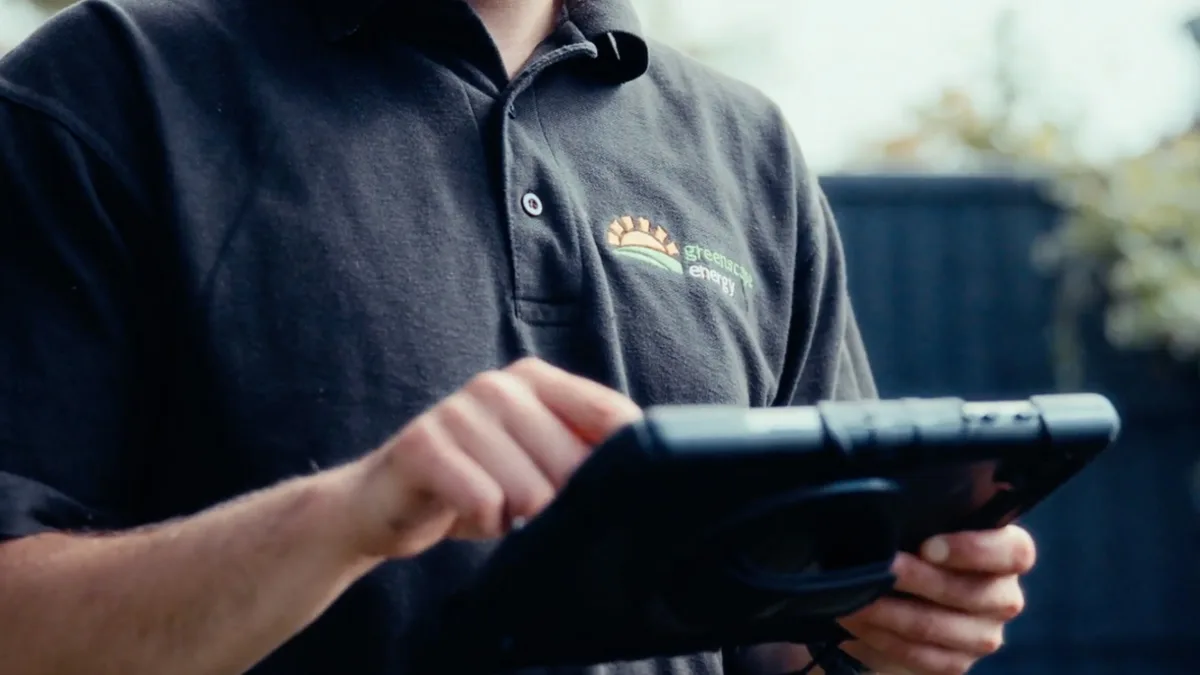 A Greenscape surveyor recording measurements on a tablet