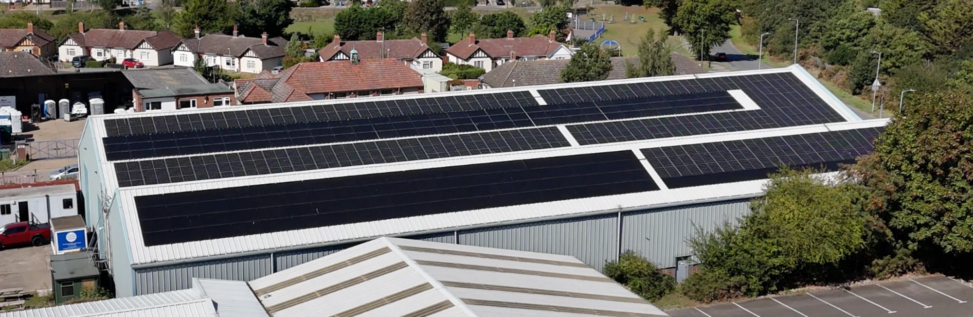 White commercial units with solar arrays on their flat roofs