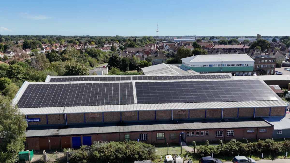 Rooftop solar across a large commercial building on the edge of town