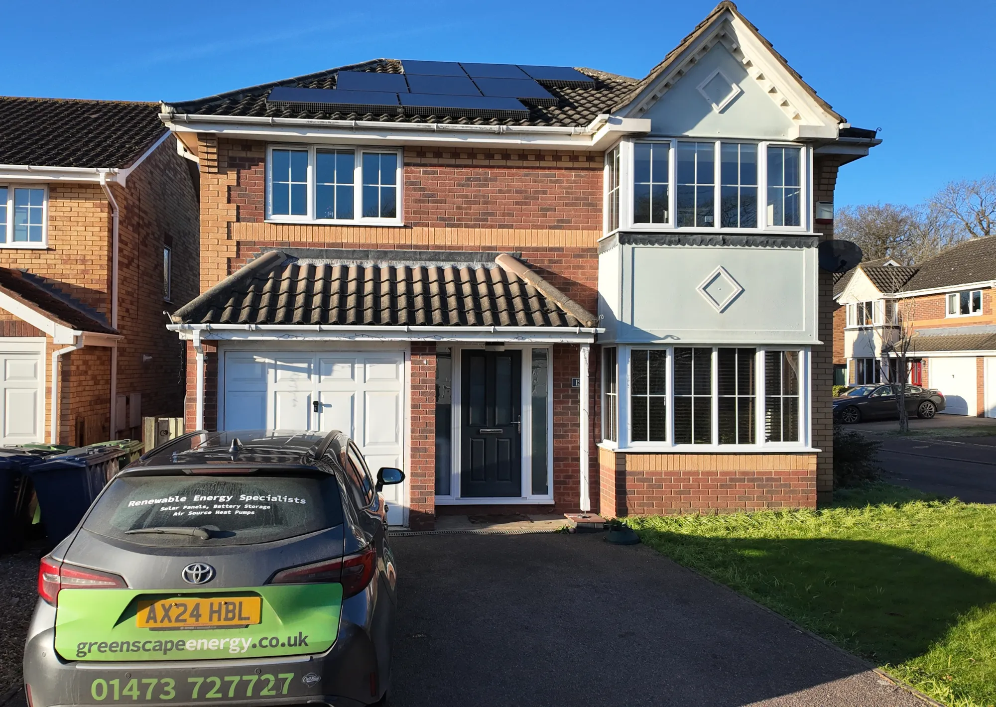 A Greenscape installer fitting panels to a tiled roof