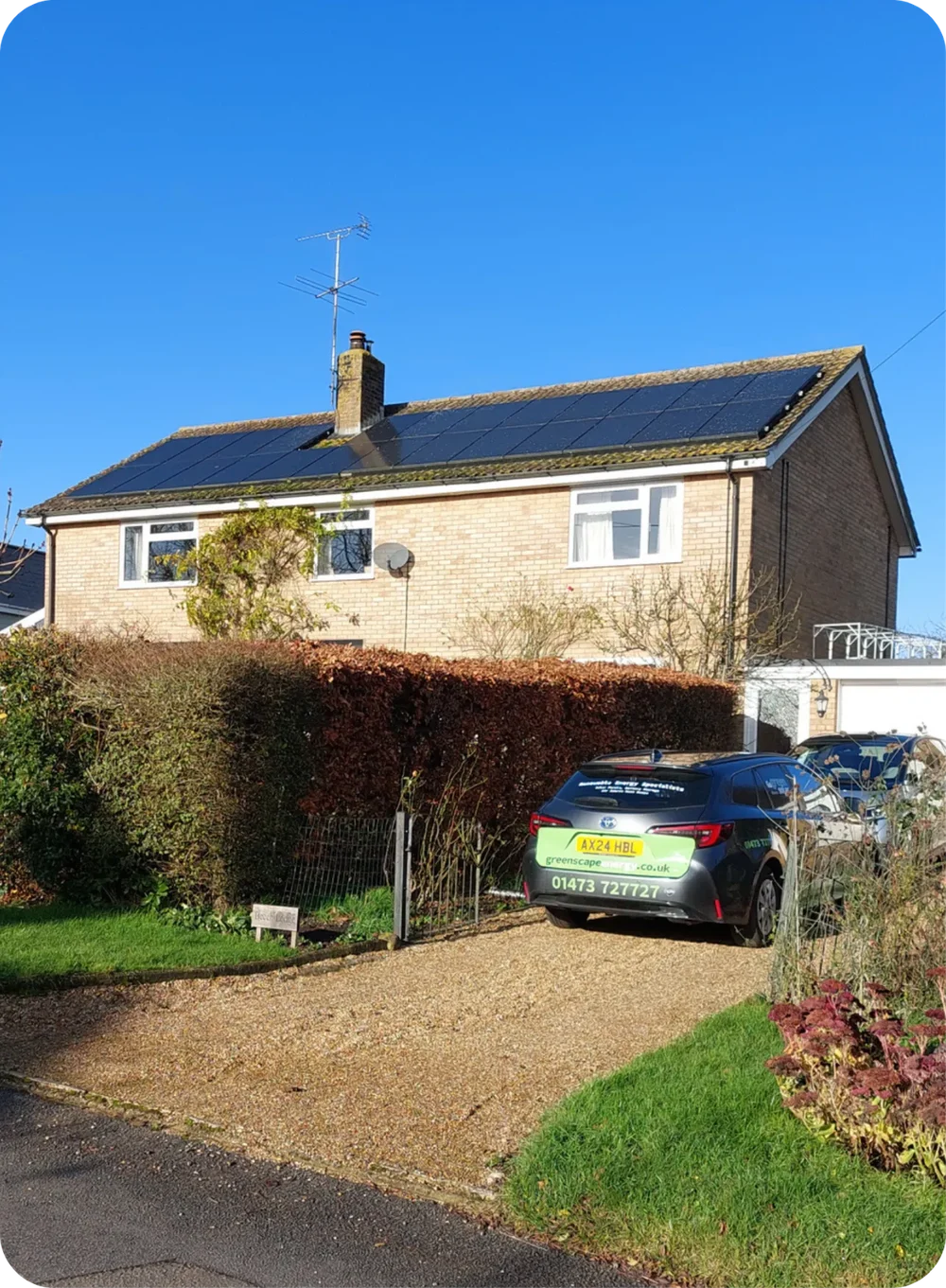 Solar PV installation on a buff-brick Suffolk home with a Greenscape van on the drive